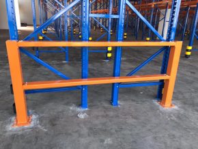 Orange protector barrier at the end of a rack aisle