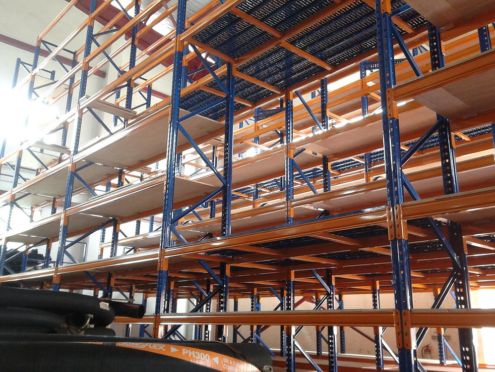 Long aisle of steel pallet racks holding stored goods